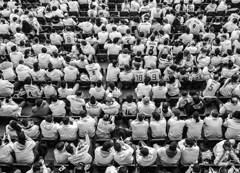 <p>Fans cheering for their club, Real Madrid at the Estadio Santiago Bernabéu, Madrid, Spain.</p>