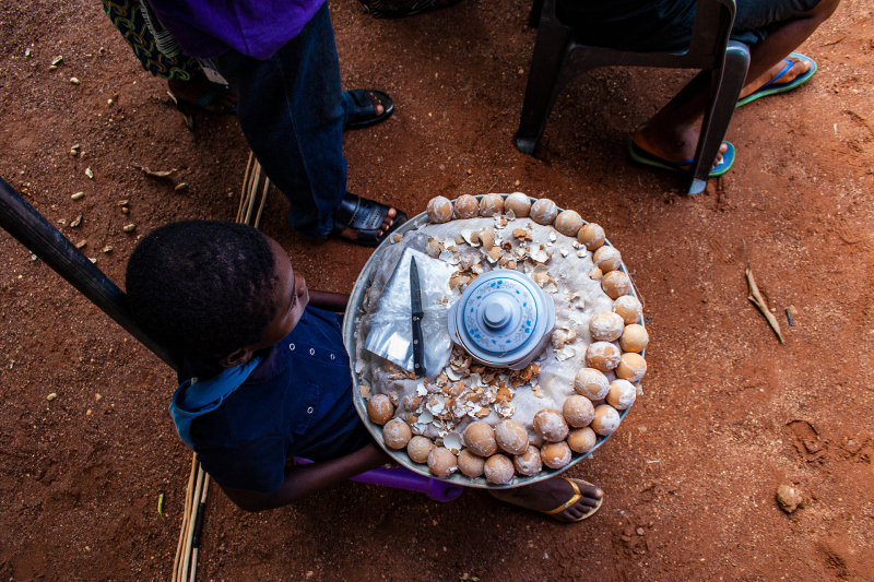 <p>A small boy selling boiled eggs at a dancing festival in Hohoe, Volta Region, Ghana. </p>