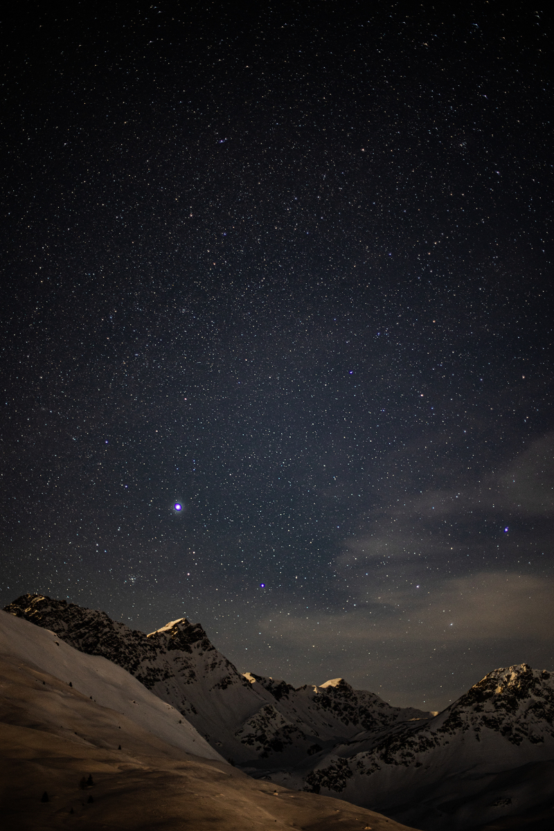 <p>Sirius - the brightest star in our solar system shines above the Swiss Alps. The clear starry sky allows the beautiful scene of light and shadow on the mountain peaks. Arosa, Switzerland.</p>